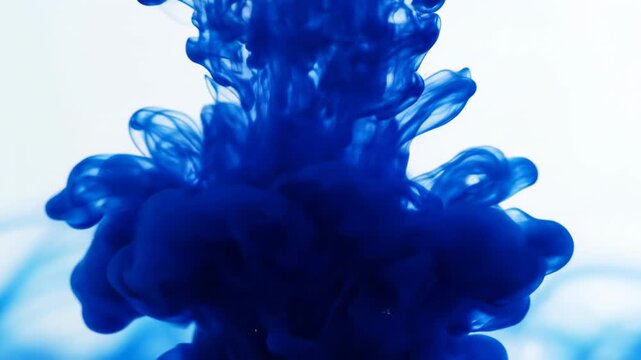Extreme slow motion macro shot of brilliant sapphire blue ink dissolving and radiating outward creating a mesmerizing chemical reaction pulse inspiration, radiating, science