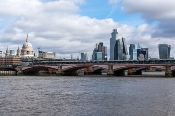 View of the river Thames in London with St. Pauls Cathedral and the skyscrapers of the City