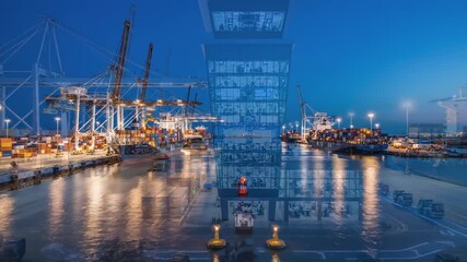 Nighttime port scene showcases busy terminal operations with illuminated control tower and moving vehicles, camera pans to capture activity and workflow - Powered by Adobe