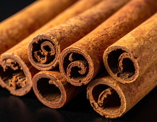Cinnamon sticks close up, warm brown tones, natural detail.