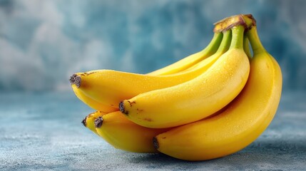 Fresh Yellow Bananas on a Blue Background with Soft Lighting, Highlighting the Smooth Texture and Vibrant Color of the Fruit for Culinary and Health-Based Visuals
