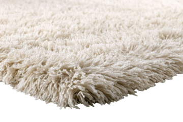 Close-up of a fluffy, cream-colored rug, showcasing texture, angled against a black backdrop