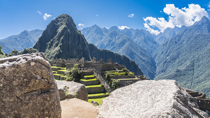 The Lost City of the Incas Machu Picchu. Green terraces, stairs on the mountainside. Dilapidated...