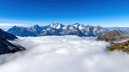 Fototapeta premium Soft rolling clouds over high peaks with atmospheric depth and serene mountain view