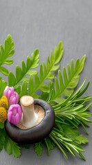A macro shot of a mushroom with flowers and green leaves on a gray background. Studio lighting.