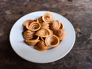kue Kuping Gajah is a traditional Indonesian snack or cookies. That has a sweet and crunchy taste, and has a spiral pattern and is shaped like an elephant's ear