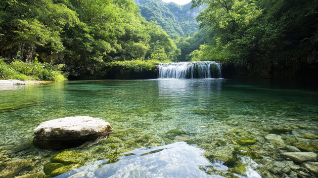 Clear green pool with small waterfall and lush forest reflection