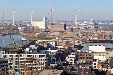 Antwerp cityscape and port with wind turbines harnessing sustainable energy, combining urban development and green technology