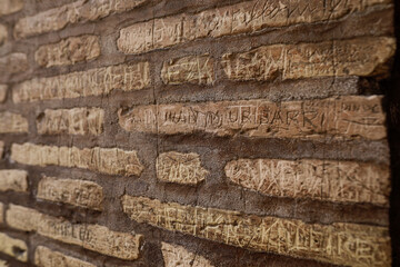 Details with tourist markings on the walls of the Colosseum in Rome.