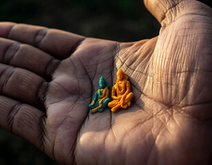 Closeup of Miniature Hindu God Figures on a Hand Symbolism, Spirituality, Colorful Statues, Focus on Religious Items.