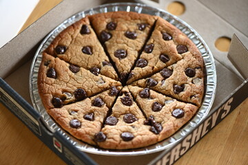 A chocolate cookie with a pizza-like appearance