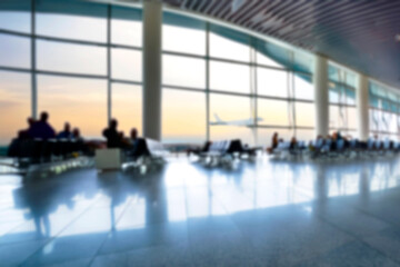 blurred people waiting for the flight departure in airport. Defocused image of an airport.