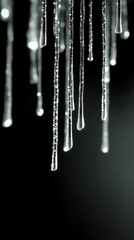 Stunning winter icicle formations against deep dark backdrop capturing cold weather beauty and seasonal frost.
