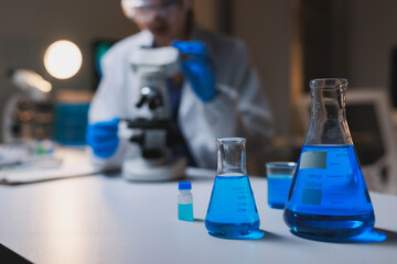 Scientist observing chemical reaction in laboratory research