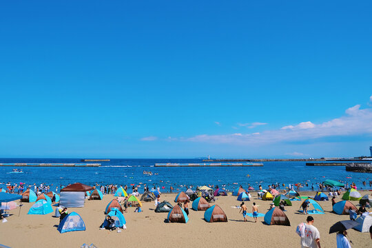 Beachgoers at a seaside area in Japan during summer