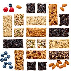 Variety of healthy homemade granola bars and fresh fruits on black background