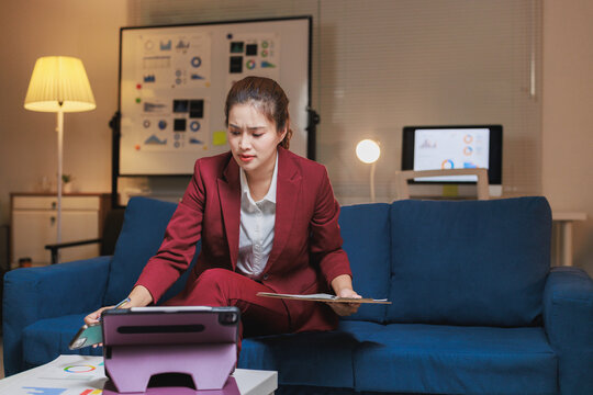 Stressed businesswoman working on marketing project late night - Powered by Adobe