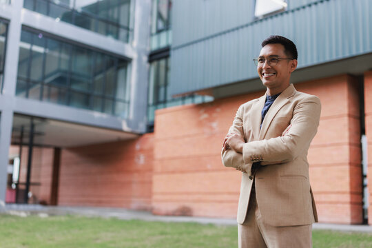 Asian businessman smiling confident standing in suit
