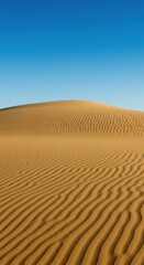 Vast, undulating golden sand dunes stretch under a clear blue sky, displaying the serene and timeless beauty of an arid wilderness ,pattern ,arid ,desolate