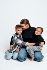 mom with children on a white isolated background hugging, motherhood, mother with two children