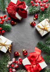 Christmas festive background with gifts, fir branches, and ornaments
