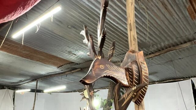 Video of wooden carving of deer.