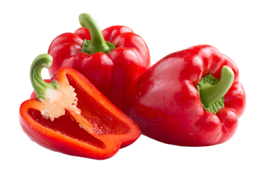 Fresh red bell peppers one halved on a dark background