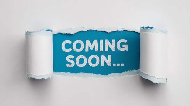 Torn paper reveals bright blue background with white text saying coming soon creating anticipation and excitement for a future event