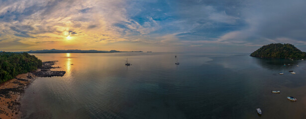 Panoramic sunrise aerial of Sakatia Island, Nosy Be, Madagascar &ndash; golden light over the ocean, tropical coastline, and peaceful island landscape.