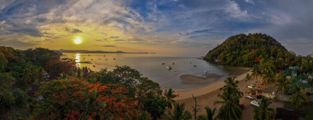 Panoramic sunrise aerial of Sakatia Island, Nosy Be, Madagascar &ndash; golden light over the ocean, tropical coastline, and peaceful island landscape.