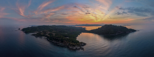 Panoramic sunrise aerial of Sakatia Island, Nosy Be, Madagascar &ndash; golden light over the ocean, tropical coastline, and peaceful island landscape.