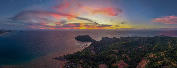 Panoramic sunset aerial of Sakatia Island, Nosy Be, Madagascar &ndash; golden light over the ocean, tropical coastline, and peaceful island landscape.