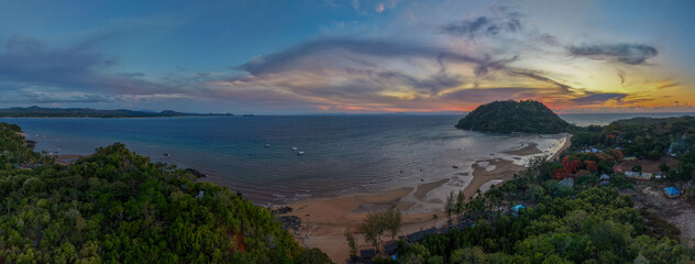 Panoramic sunset aerial of Sakatia Island, Nosy Be, Madagascar &ndash; golden light over the ocean, tropical coastline, and peaceful island landscape.