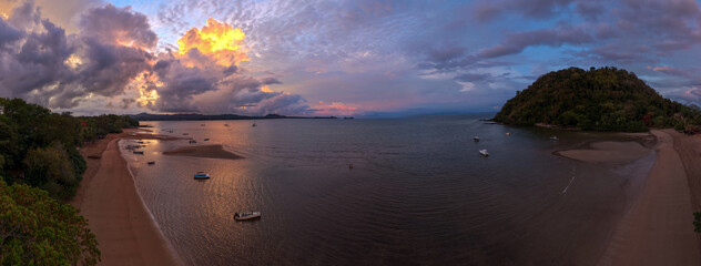 Panoramic sunrise aerial of Sakatia Island, Nosy Be, Madagascar &ndash; golden light over the ocean, tropical coastline, and peaceful island landscape.
