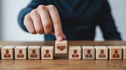 Obraz premium Business professional selects a wooden block symbolizing agreement among a row of personnel icons