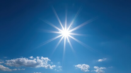 A radiant sun shines brightly in a clear blue sky illuminating the day. Soft white clouds float gently across the expanse creating a serene atmosphere.