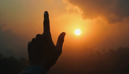 Fototapeta premium Hand Silhouette Pointing at Sunset Sun