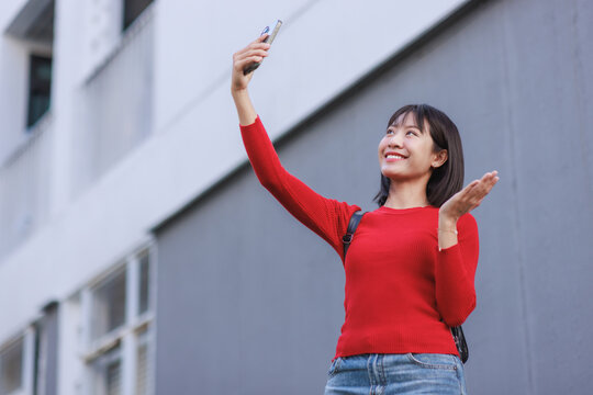 Young asian woman creating mobile video content