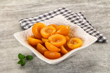 Sweet canned apricots with syrope