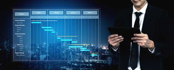 A businessman in a suit holds a tablet while overseeing a digital Gantt chart set against an urban night skyline, emphasizing project management and planning. Tessel