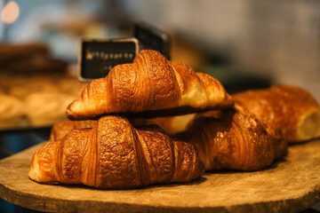 Freshly made croissants stacked on a counter in a cafe