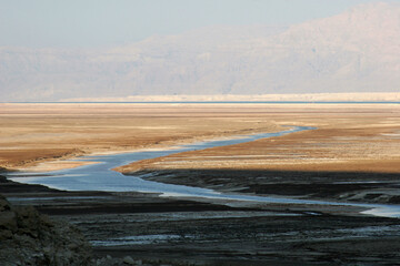 A sinkhole caused by the receding water level of the Dead Sea. A hot water spring fills the hole, Dead Sea, Israel