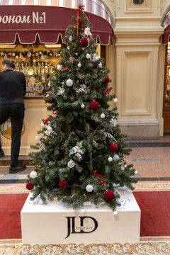 Russia. Moscow. December 1, 2025. GUM store. Christmas tree with red and white ornaments on JLD beauty base in mall interior