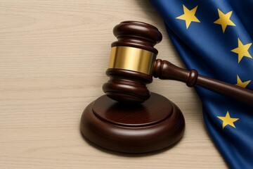 Obraz premium Judge gavel with golden band and EU flag on wooden background symbolizing European law, legislation, and justice system concept in legal context. Ai generative