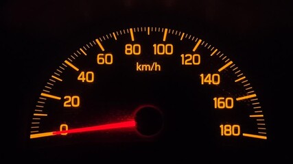 Footage of speedometer of a car instrument cluster on black background
