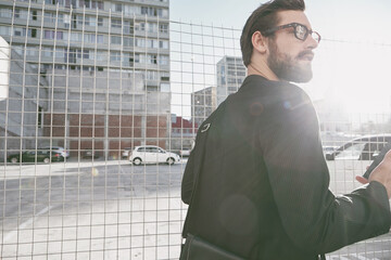 Thinking, business and man with phone in city for travel, online directions and real estate listing. Male relator, mobile and reflection for urban development, commute navigation and expansion offer