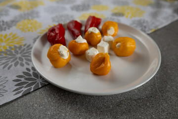 Stuffed peppers and cheese appetizer variety side view
