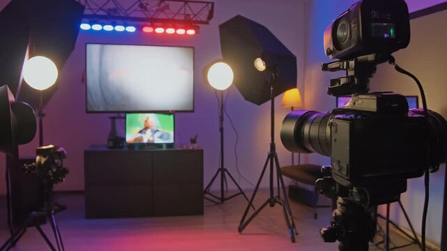 A vibrant studio setup featuring cameras, lighting equipment, and screens, designed for vide 