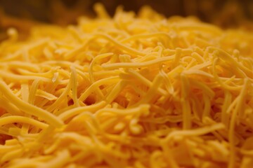Fototapeta premium Close up of a pile of grated cheese, creating an enticing texture