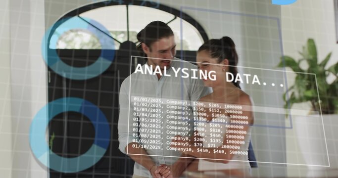 Studying man and woman in office wearing white shirt and sleeveless top analyzing data on glass
